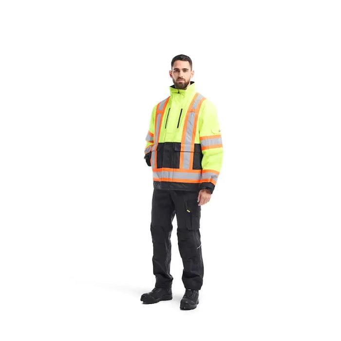 Person wearing a high-visibility safety jacket and pants on a white background